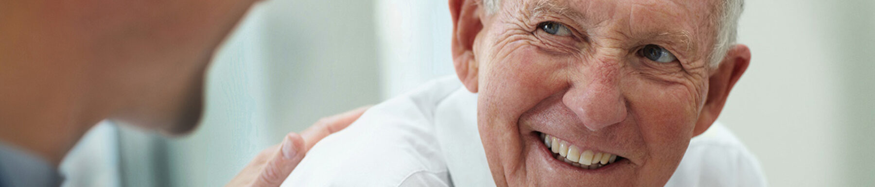 Happy senior citizen having a casual small talk with the friendly doctor